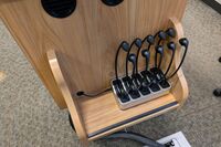 View of microphones in charging base on pedestal side