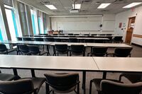 Front of room view with lectern on left in front of markerboard 