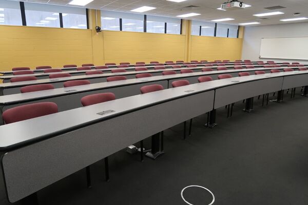 Back of room view of student fixed-table and chairs seating 
