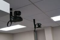 Cameras mounted to ceiling and instructor enabled adjustments to the lens to allow the instructor to be "seen" by the camera in more locations around the room