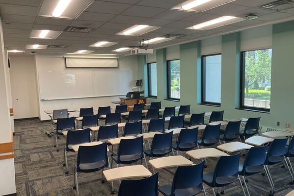 Front of room view with lectern on right in front of markerboard 