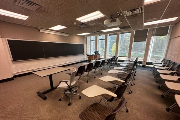 Front of room view with lectern on right in front of chalkboard 