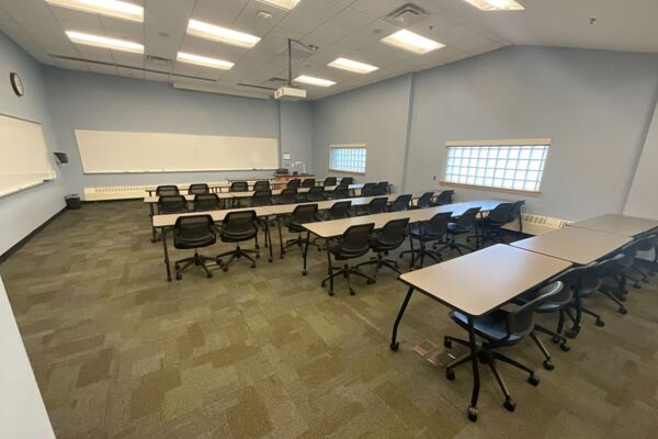 Front of room view with lectern on right in front of markerboard