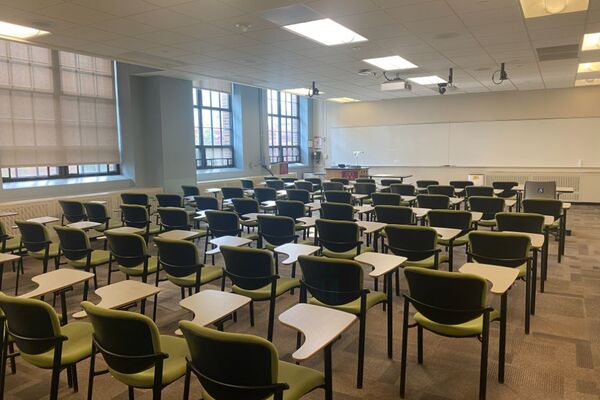 Front of room view with lectern on left in front of markerboard 