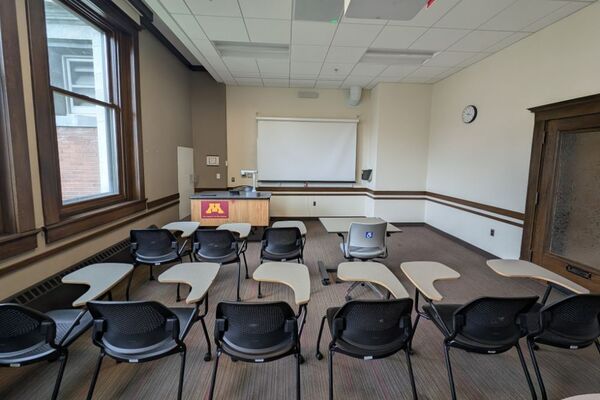 Front of room view with lectern on left in front of markerboard