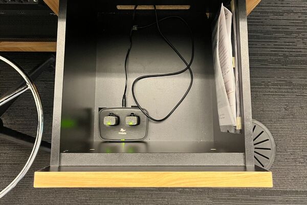 Pedestal - inside view of drawer showing two wireless mics in charging base 