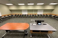 Back of room view of student tablet arm seating and markerboards on side and back walls