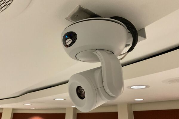 Camera mounted to ceiling and instructor enabled adjustments to the lens to allow the instructor to be "seen" by the camera in more locations around the room