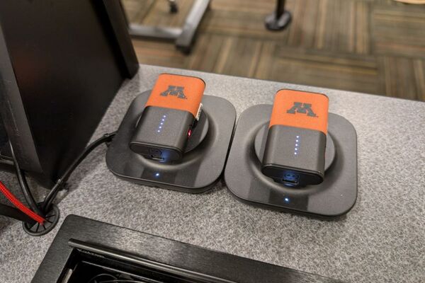 Microphones on top of instructor pedestal with charging base