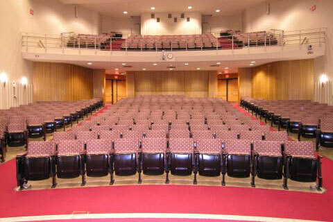 Photo looking out across auditorium from the stage, includes balcony seating.