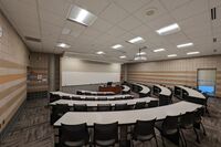 Front of room view with lectern on center in front of markerboard