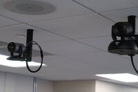 Cameras mounted to ceiling and instructor enabled adjustments to the lens to allow the instructor to be "seen" by the camera in more locations around the room