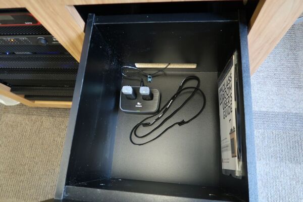 Pedestal - inside view of drawer showing two wireless mics in charging base