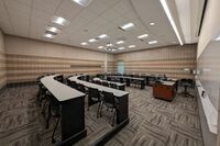 Back of room view of student fixed-table and chair seating 