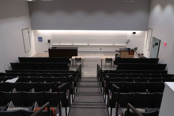 Front of room view with lectern on right side and demonstration bench on left