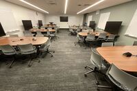 View of student active learning table and chair seating, multiple markerboards and student display monitors