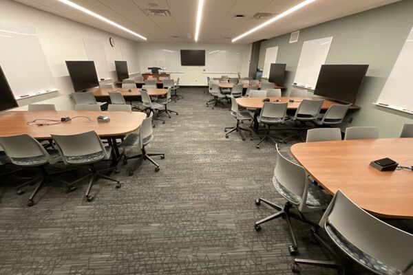 View of student active learning table and chair seating, multiple markerboards and student display monitors
