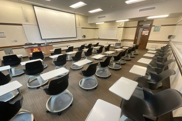 Front of room view with lectern on left in front of markerboard 