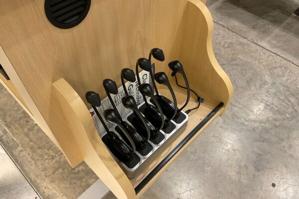 Assisted listening devices on pedestal shelf