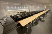 Front of room view with lectern on left side and demonstration bench on right side