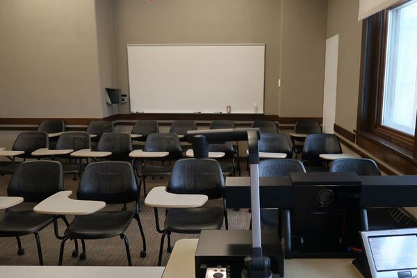 Back of room view of student tablet arm seating and markerboard on rear wall