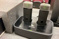 View of microphones in charging base on pedestal
