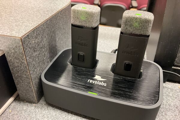 View of microphones in charging base on pedestal