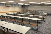 Front of room view with lectern on left in front of markerboard 