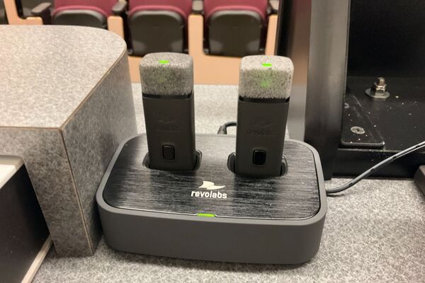 Wireless microphones in charging base on pedestal 